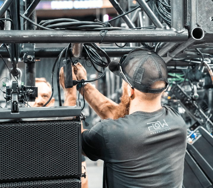 Audio engineer mixing live sound at a Flow Productions event