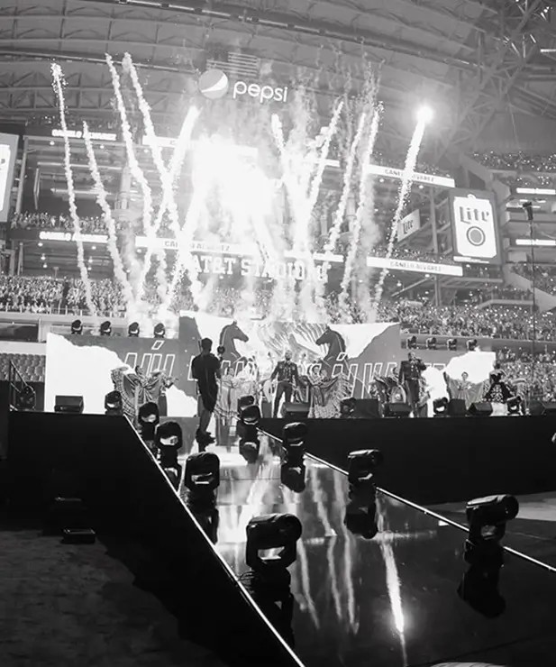Flow Productions stage rig with lighting trusses and pyrotechnics at a live show