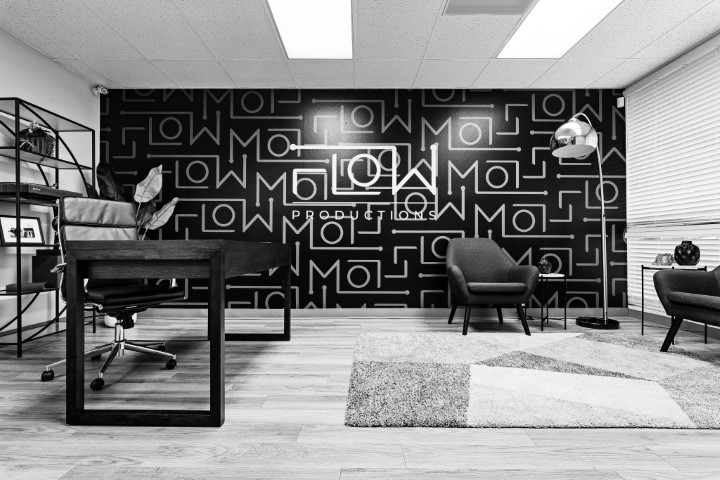 Flow Productions studio lounge with branded logo-pattern wall